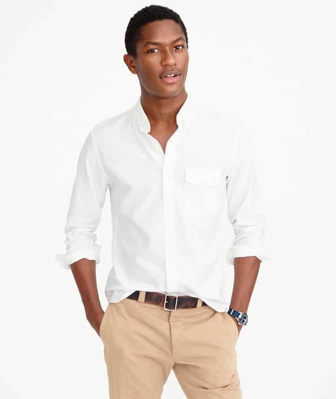 Man wearing a white oxford shirt and khaki chinos