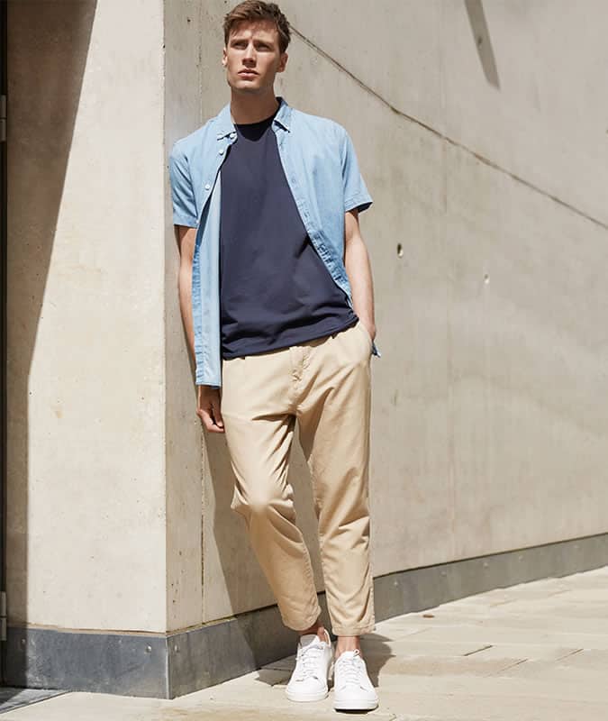 Short sleeve shirt worn over a t-shirt with chinos and sneakers