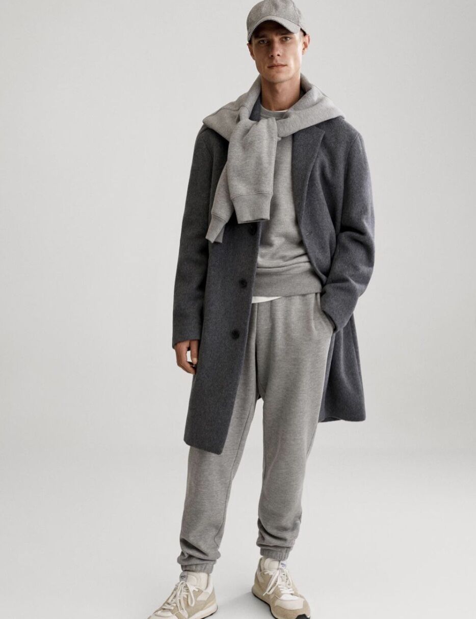 model wearing men's sweatpants and sweatshirts all grey