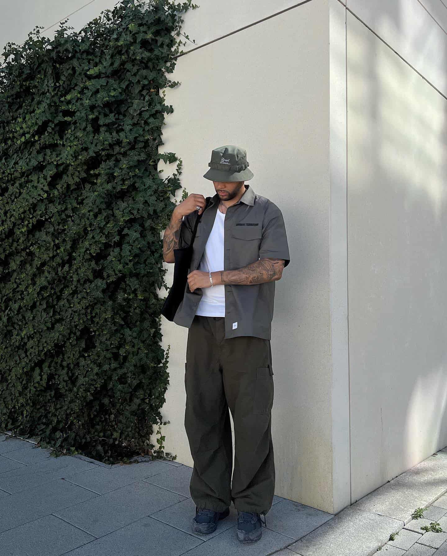 man wearing a bucket hat carrying a tote bag