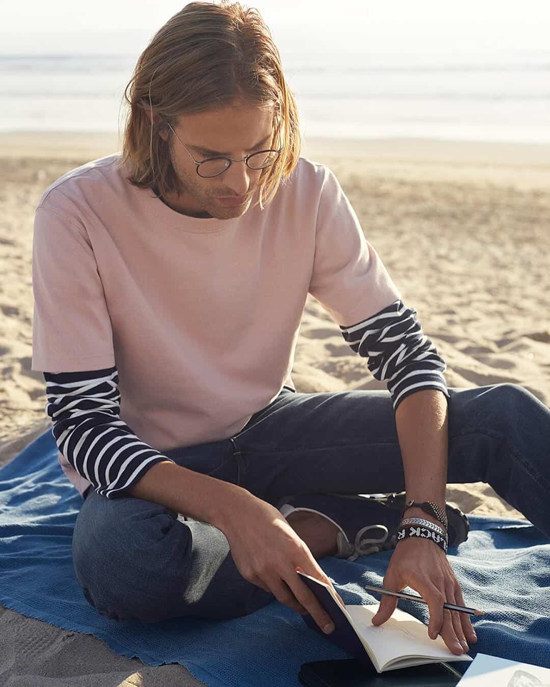 man reading notes by the beach