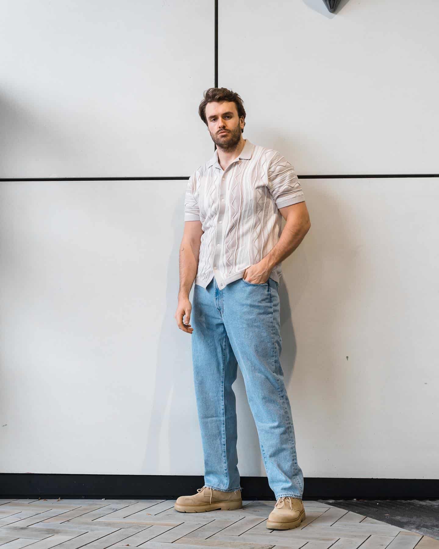 man in a shirt and light blue jeans