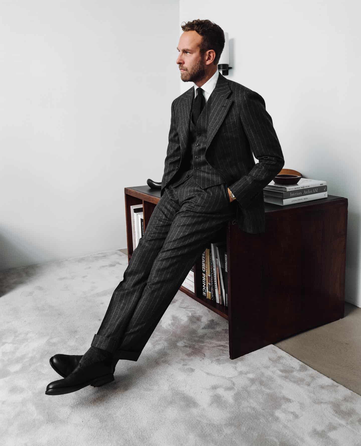 man in a suit sitting on the table