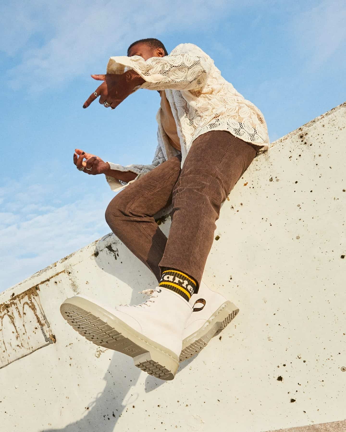 man sitting on top of a wall