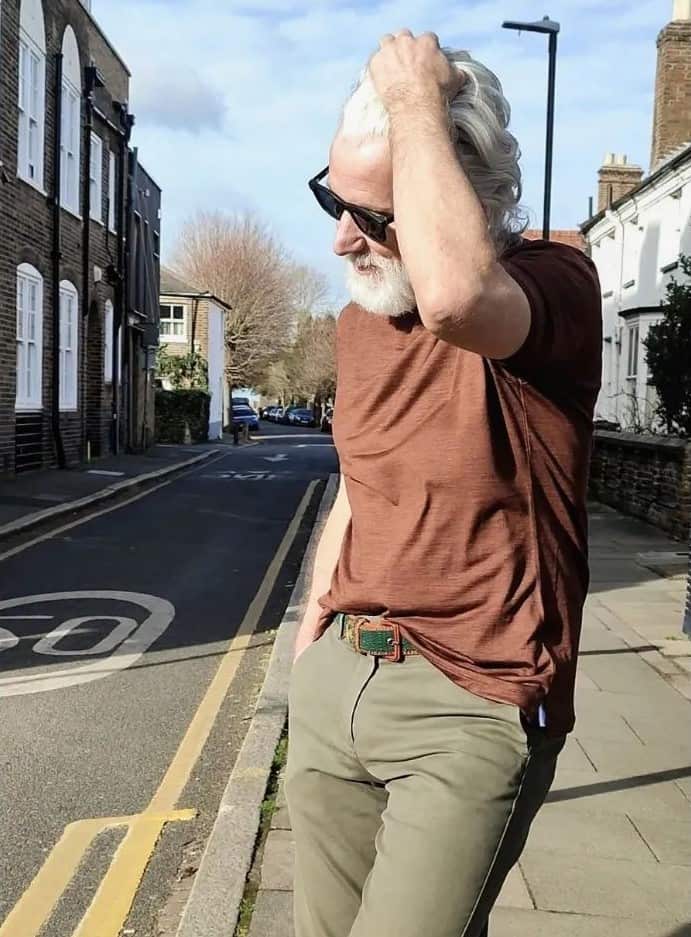 man with sunglasses fixing his hair