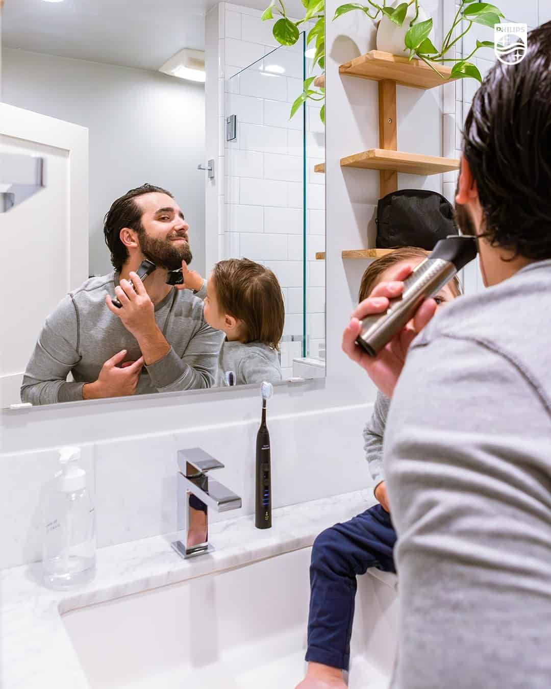 man trimming his beard in-front of a mirror