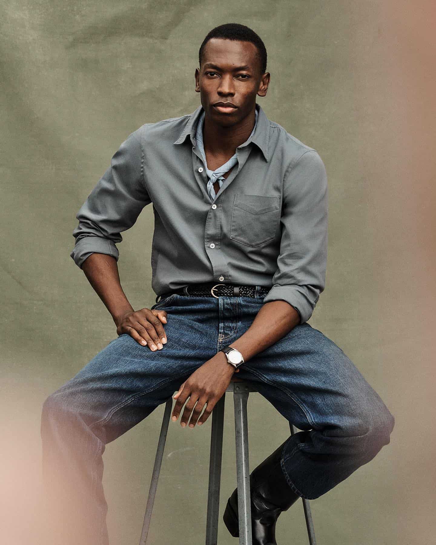 man sitting on a stool chair