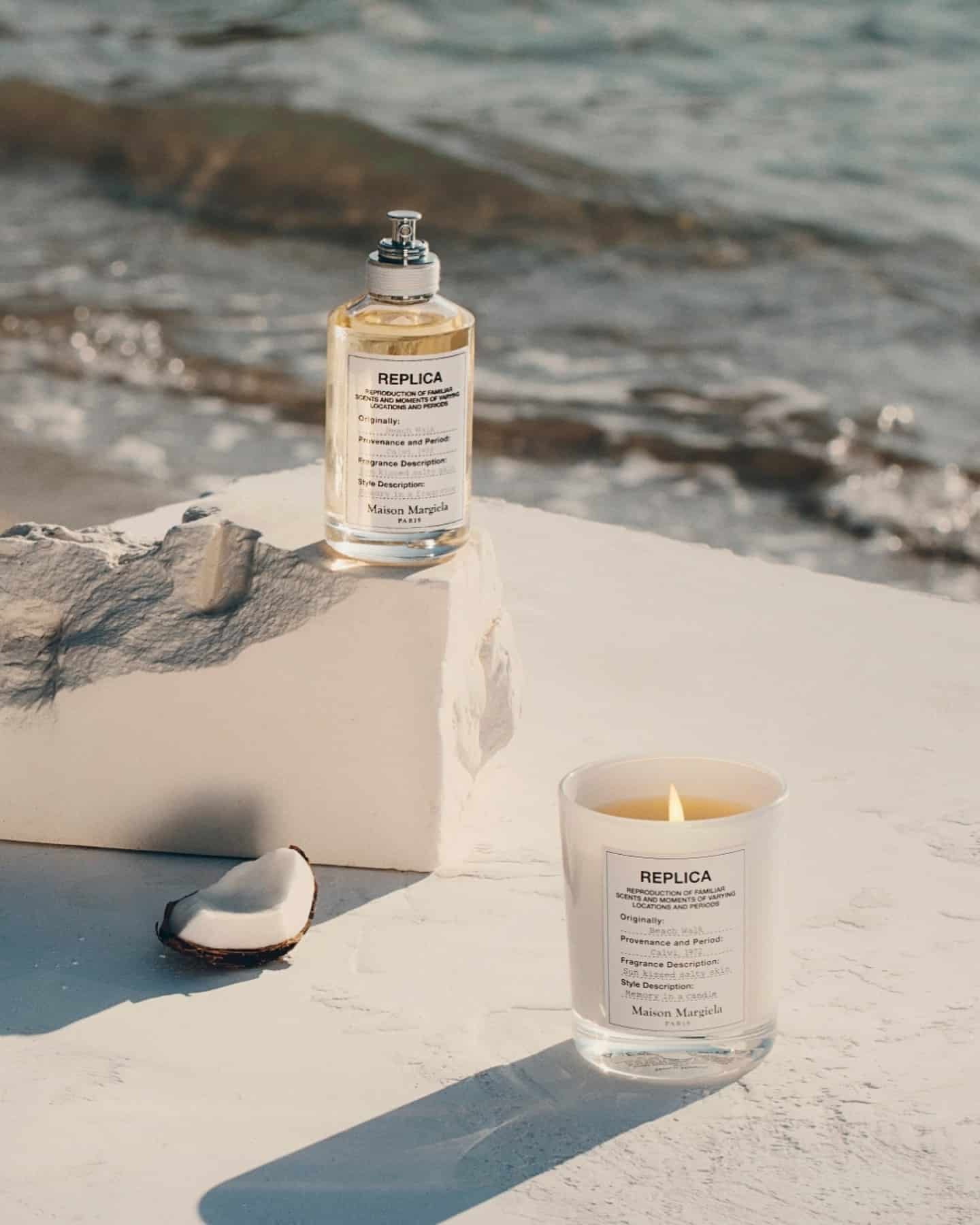 a candle and a perfume bottle of beach walk scent