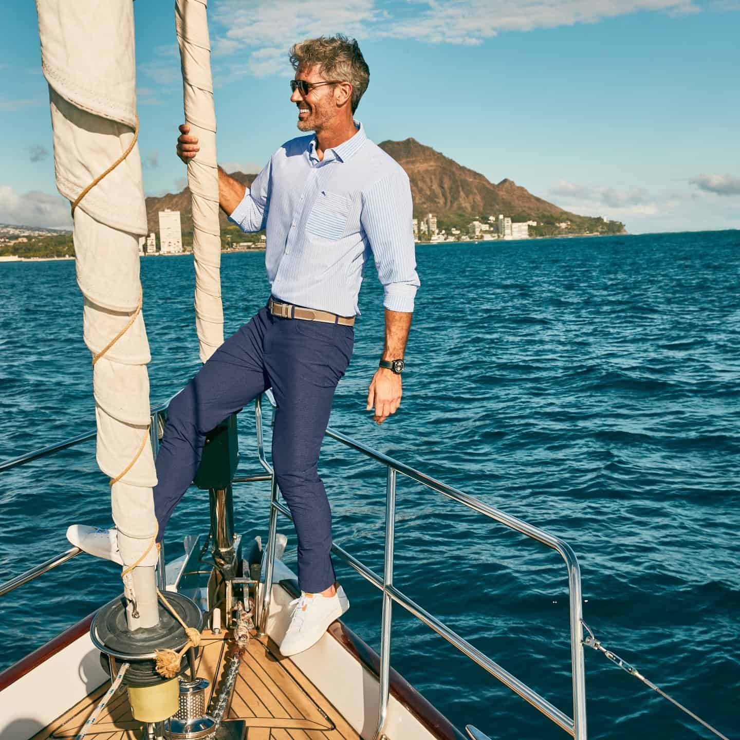 man standing on the front of the boat