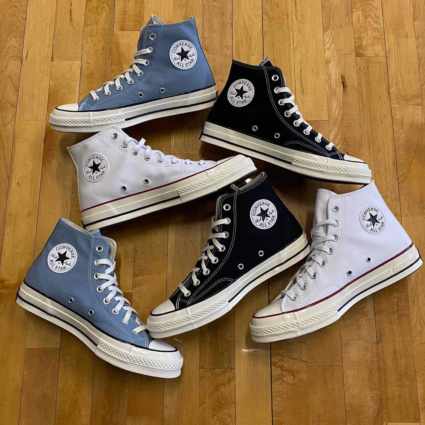 three pairs of hi top sneakers by converse