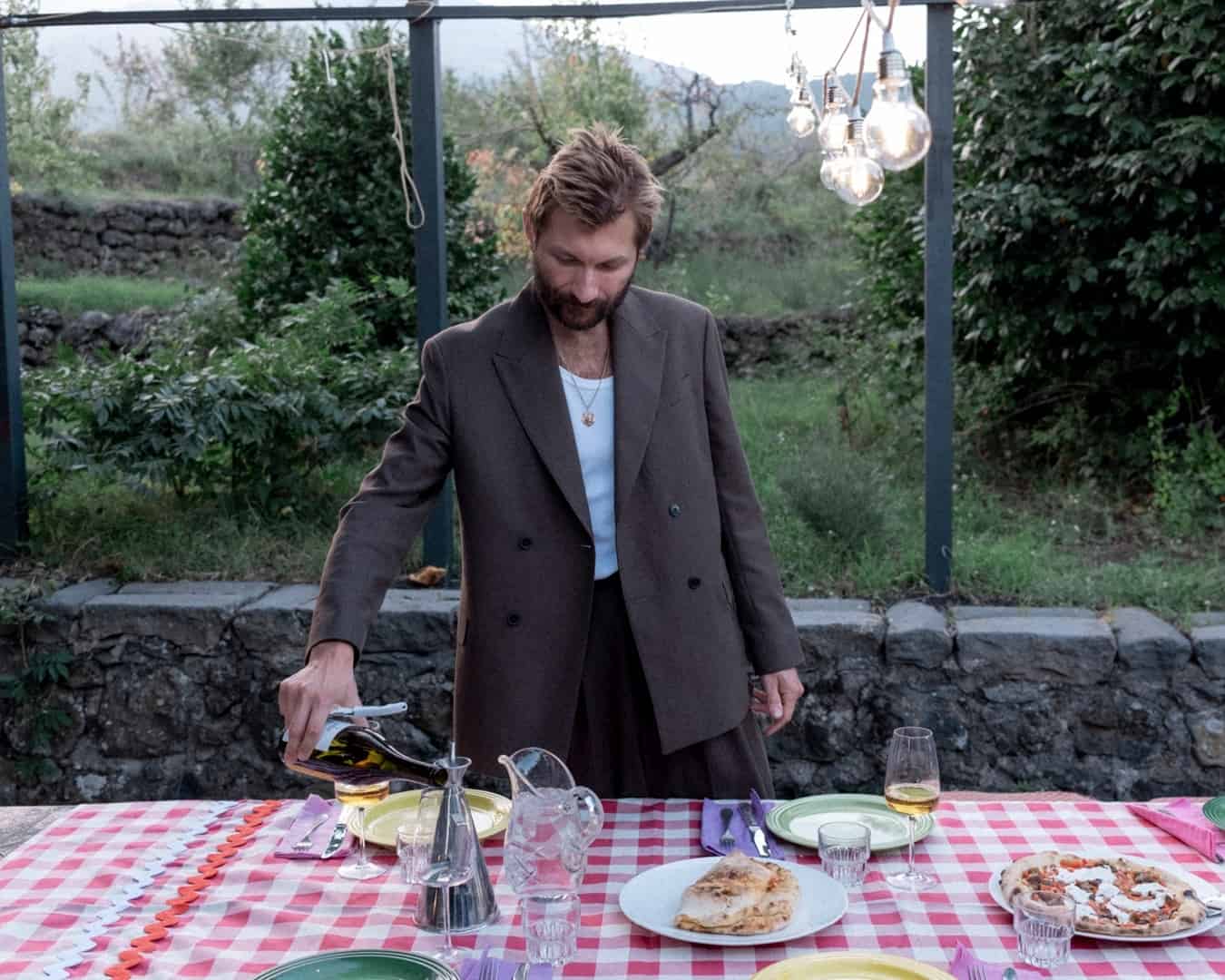 man pouring wine in to glass