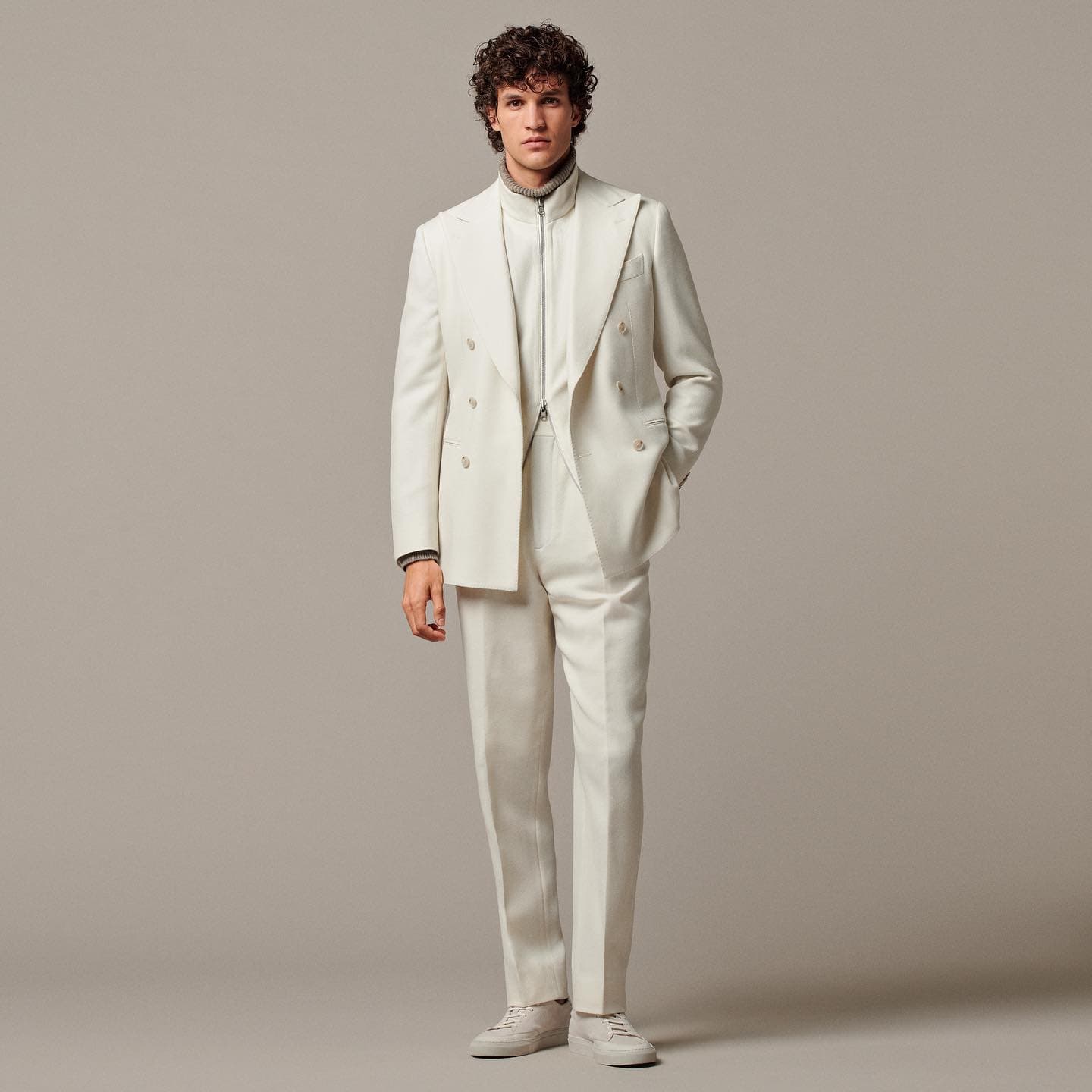 man in an off-white suit