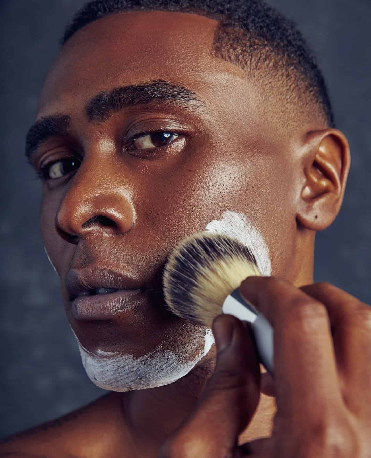 man applying shaving cream on face