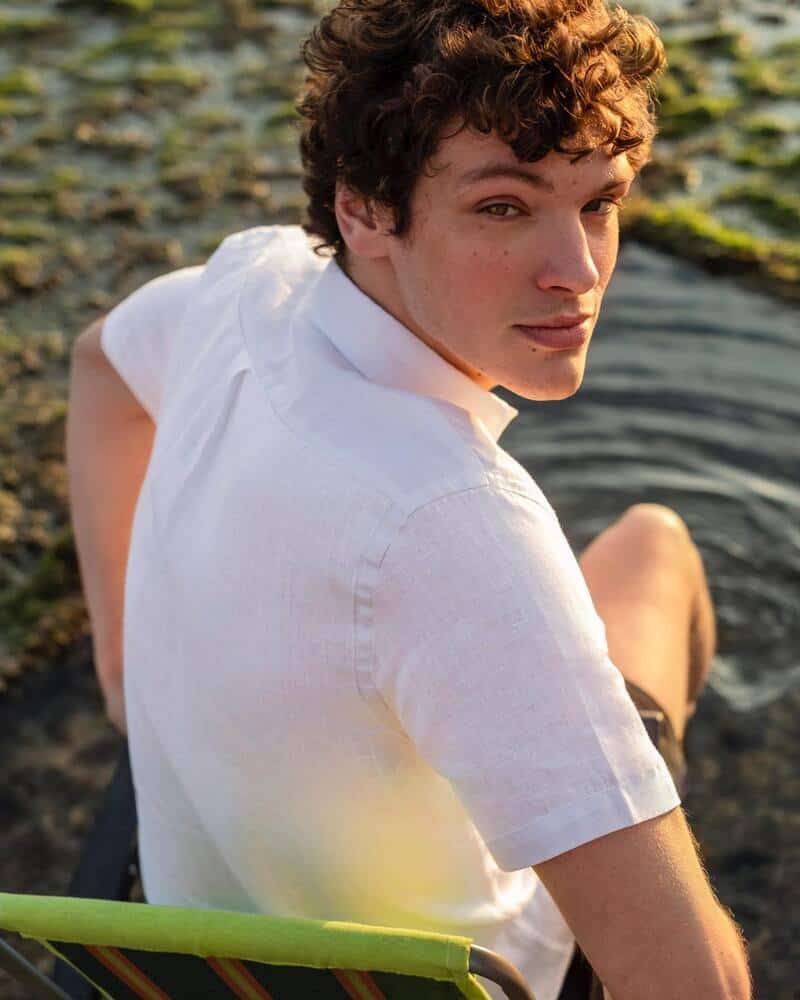 man sitting on a portable chair placed in the water