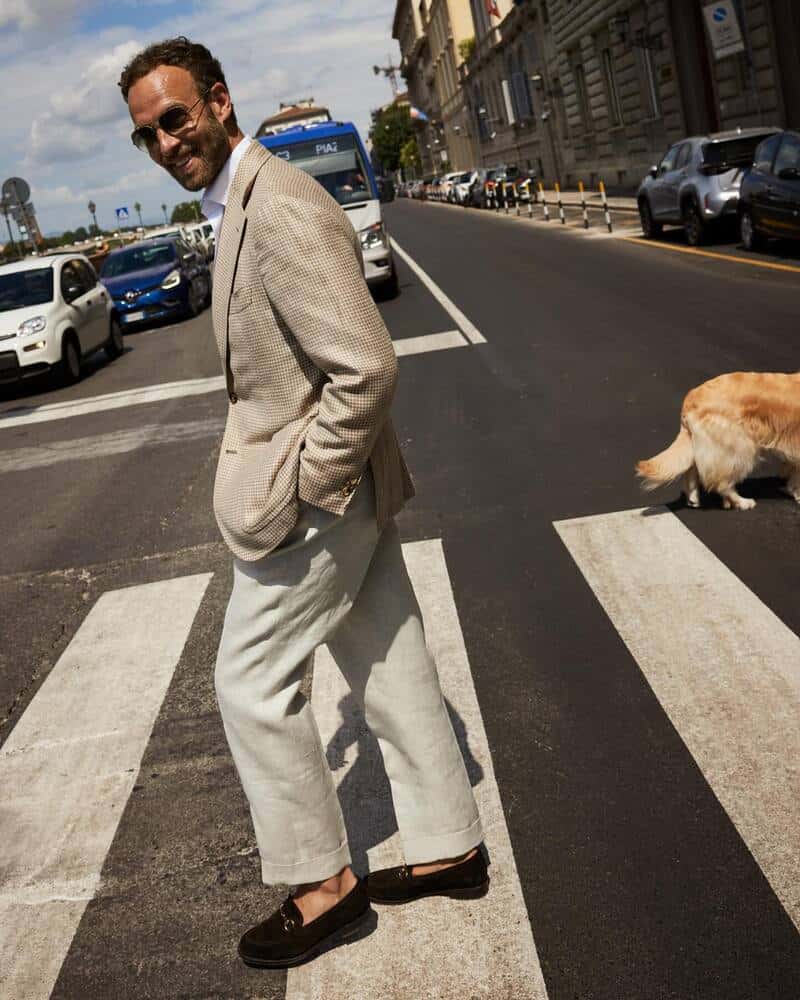 man in a checked blazer crossing the street