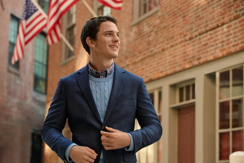 man wearing a blue blazer over a light blue cable knit sweater