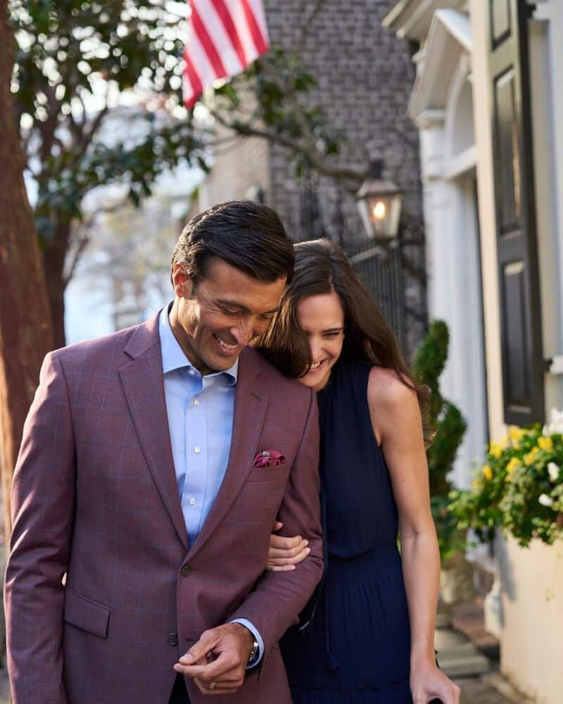 a happy couple outside a house