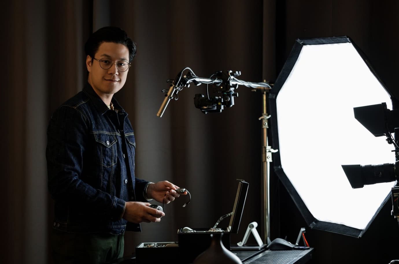 Chris Tran from Clicky Bezel showing studio/recording set up, looking at the camera and smiling