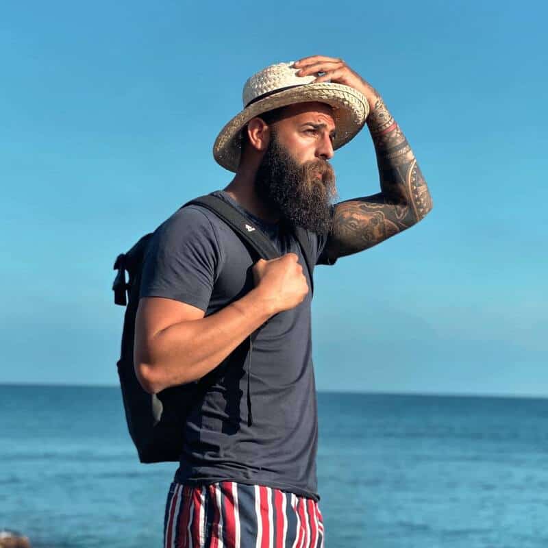 man in a straw hat by the beach