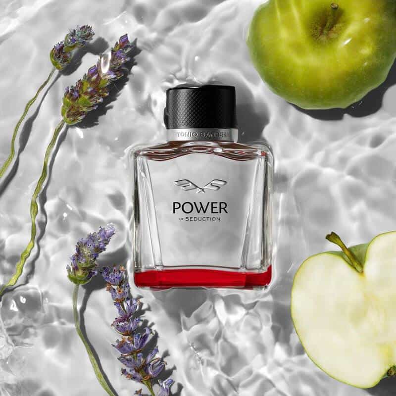 a bottle of power of seduction cologne floating on water