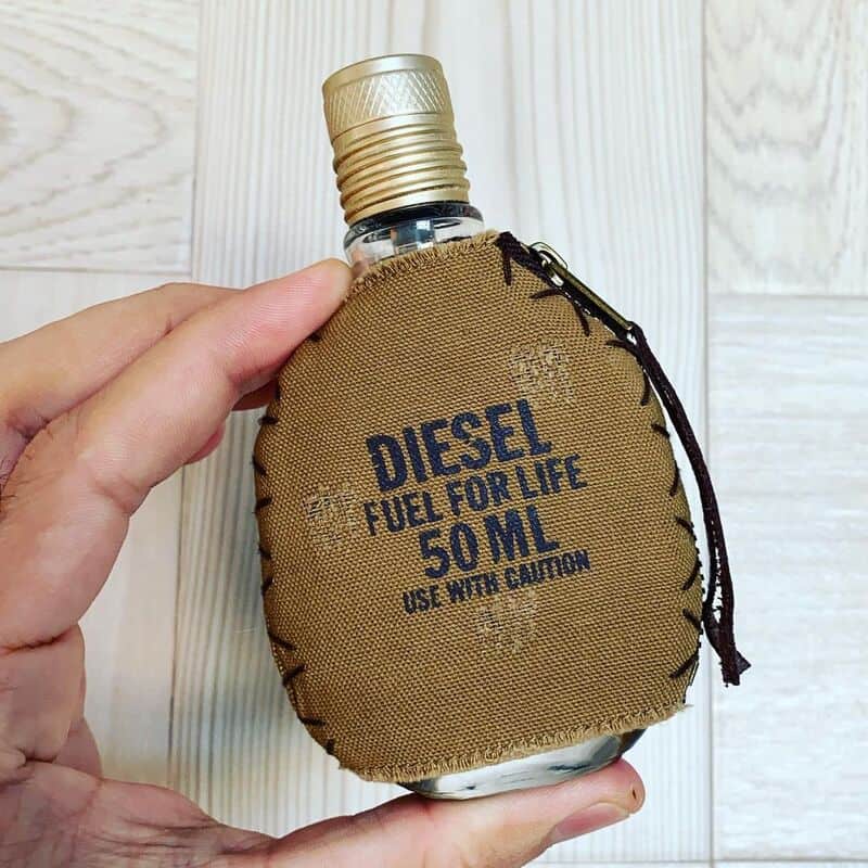 man holding the fuel for life cologne by diesel