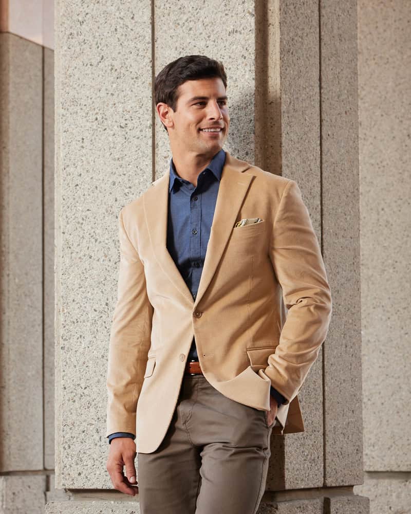 man in a tan corduroy jacket and brown pants