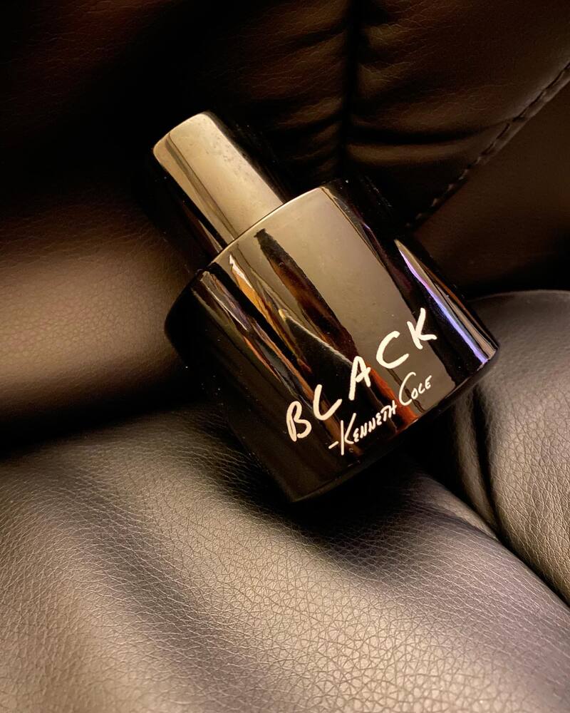 a bottle of kenneth cole black on a leather chair