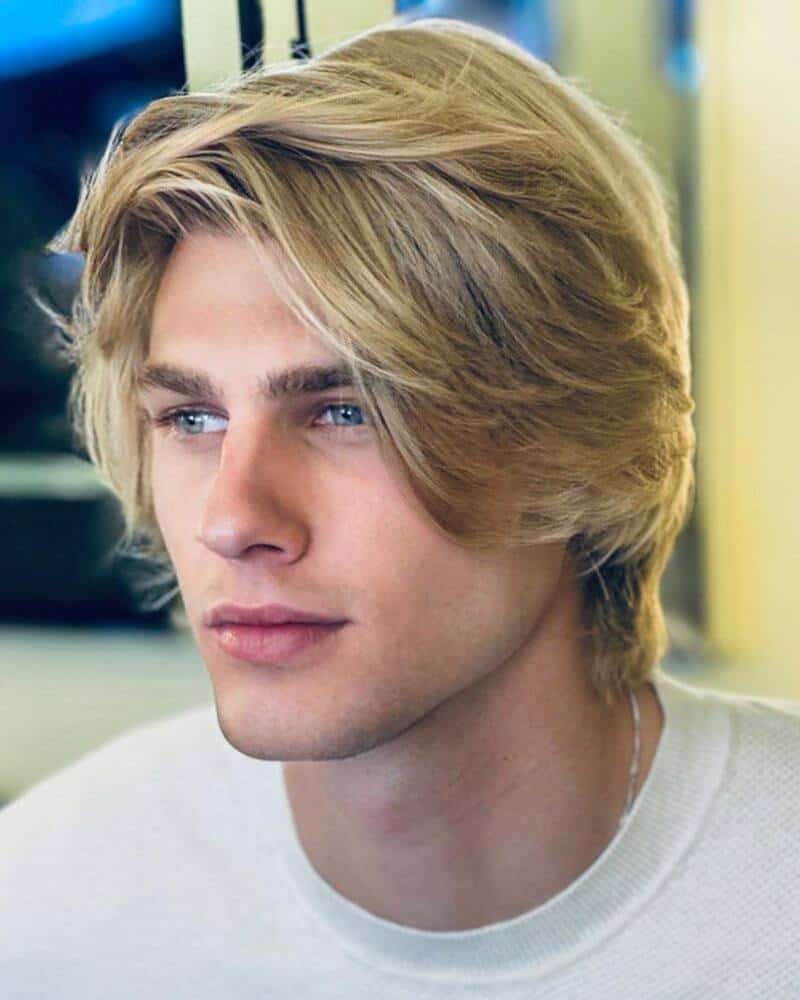 man with a layered mid-length blonde hair