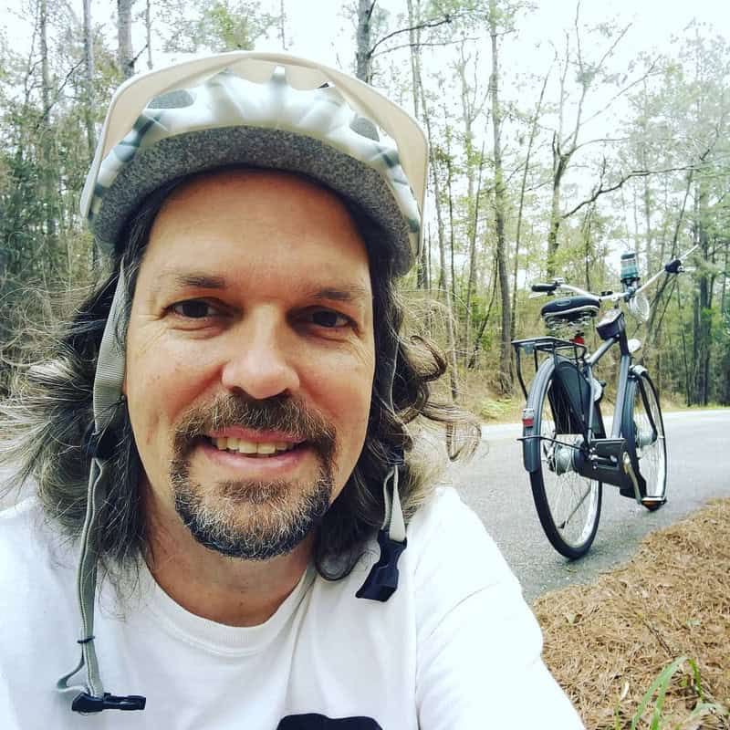 man in a bicycle helmet with circle beard style