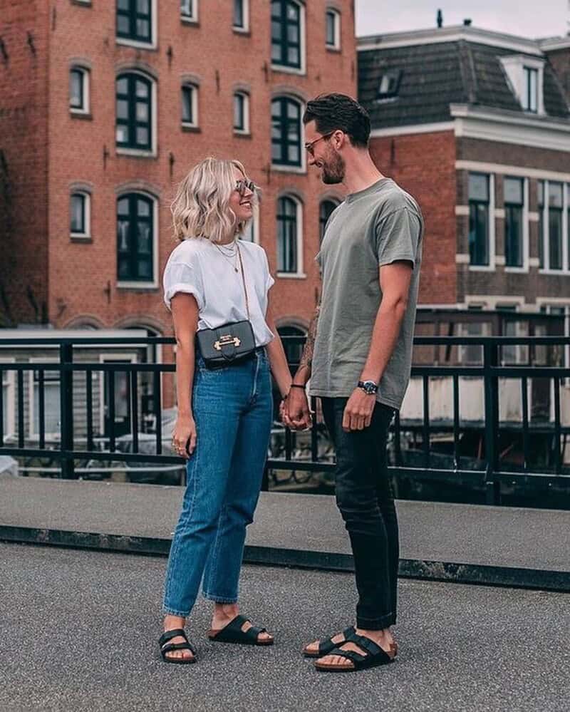 couples standing on a bridge while holding hands