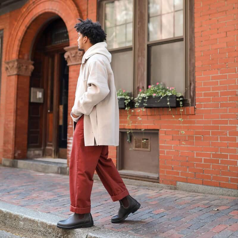 man wearing blundstone 500 with red pants and white jacket