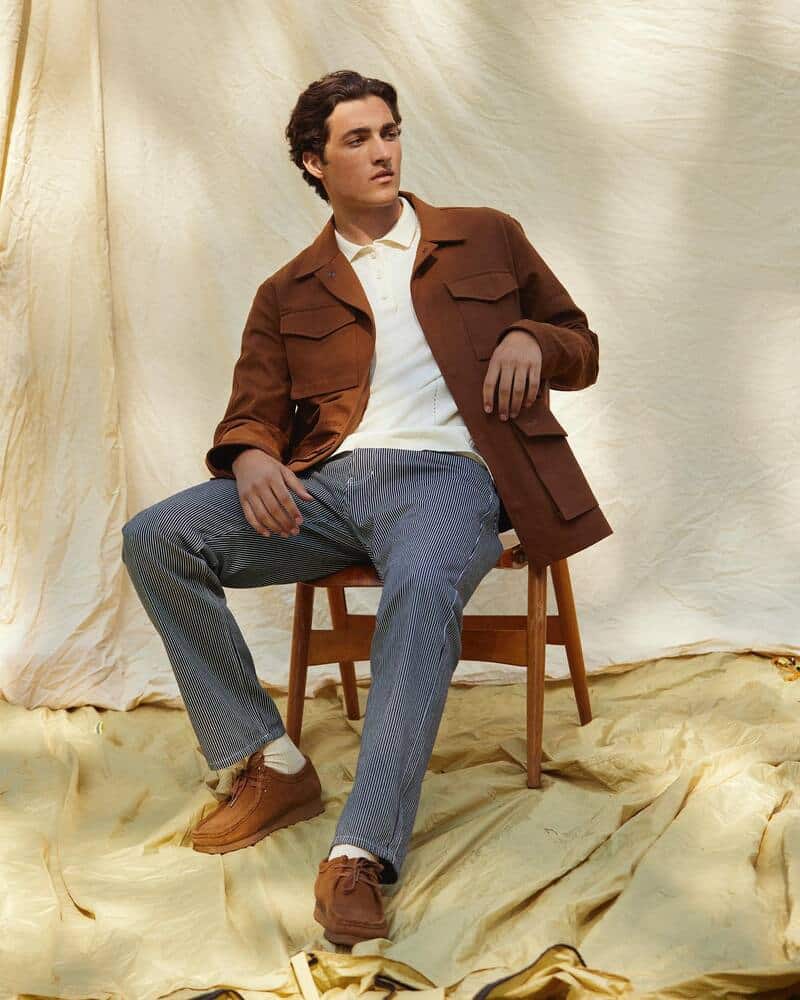 man on a chair wearing the yoke field jacket by foret