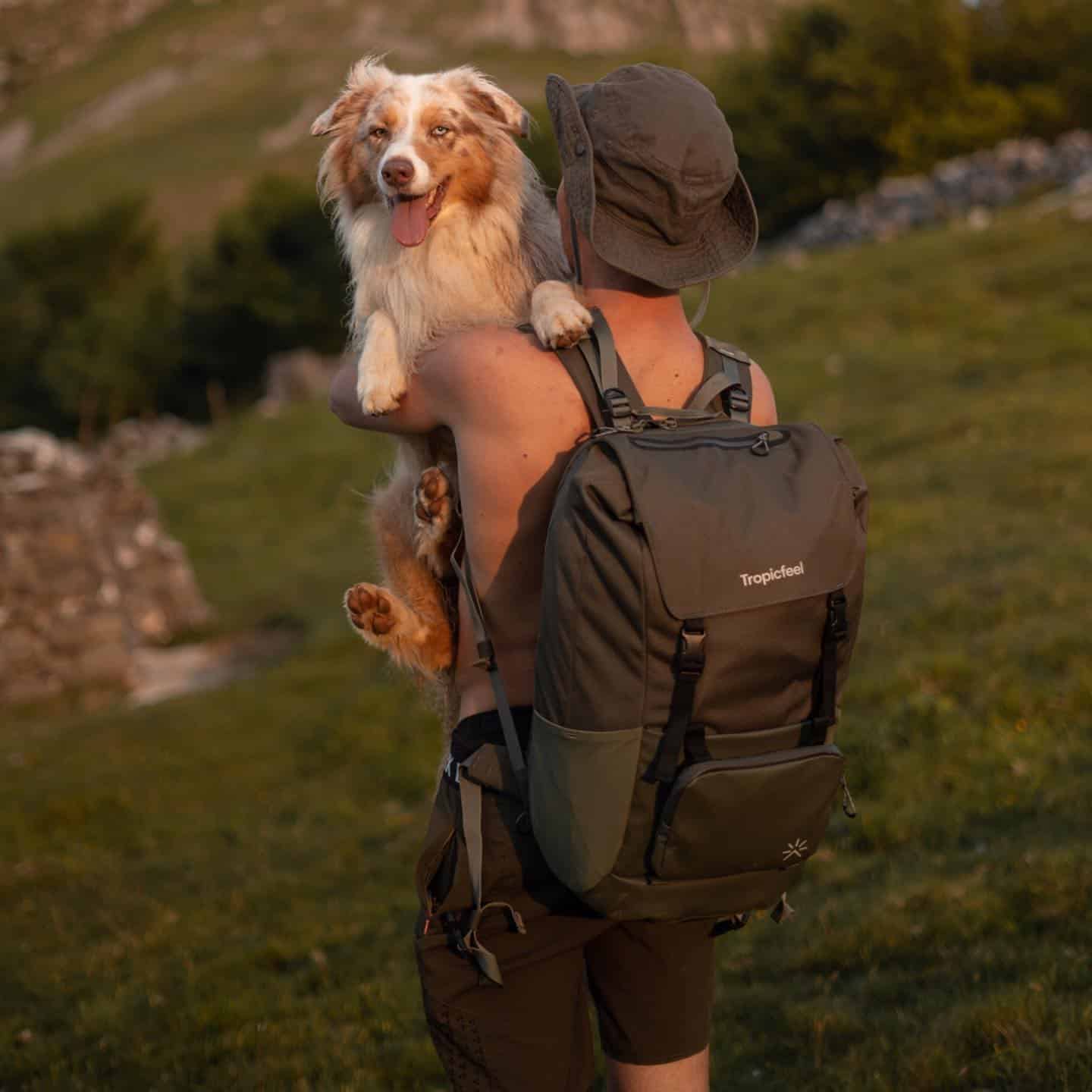 man carrying his dog