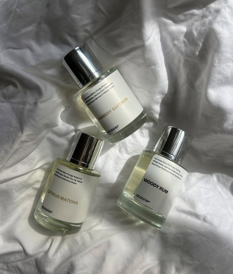 bottles of Citrus Matcha, Ambery Saffron and Woody Rum perfumes by Dossier